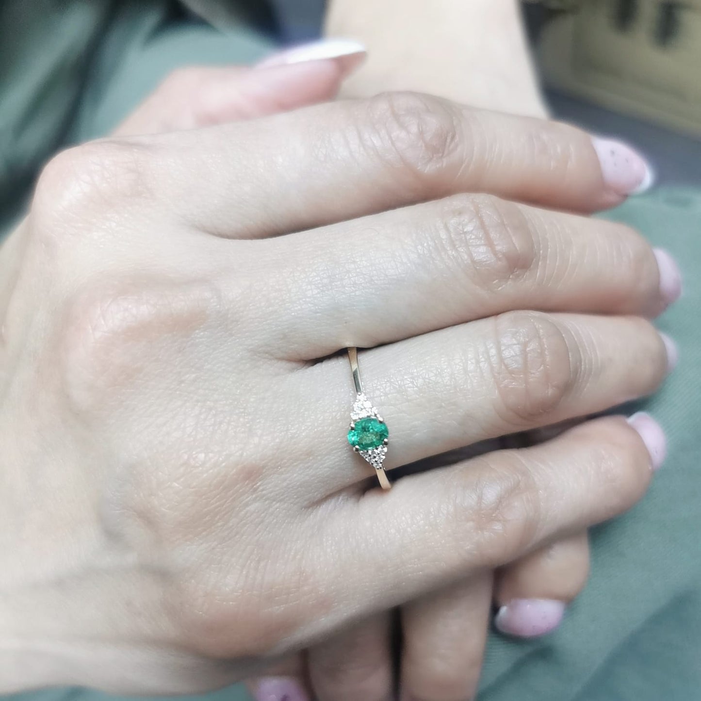 Petite 18K gold ring featuring a 0.30-carat emerald center stone, accented by 0.06-carat diamonds. Perfect for stacking or wearing alone.