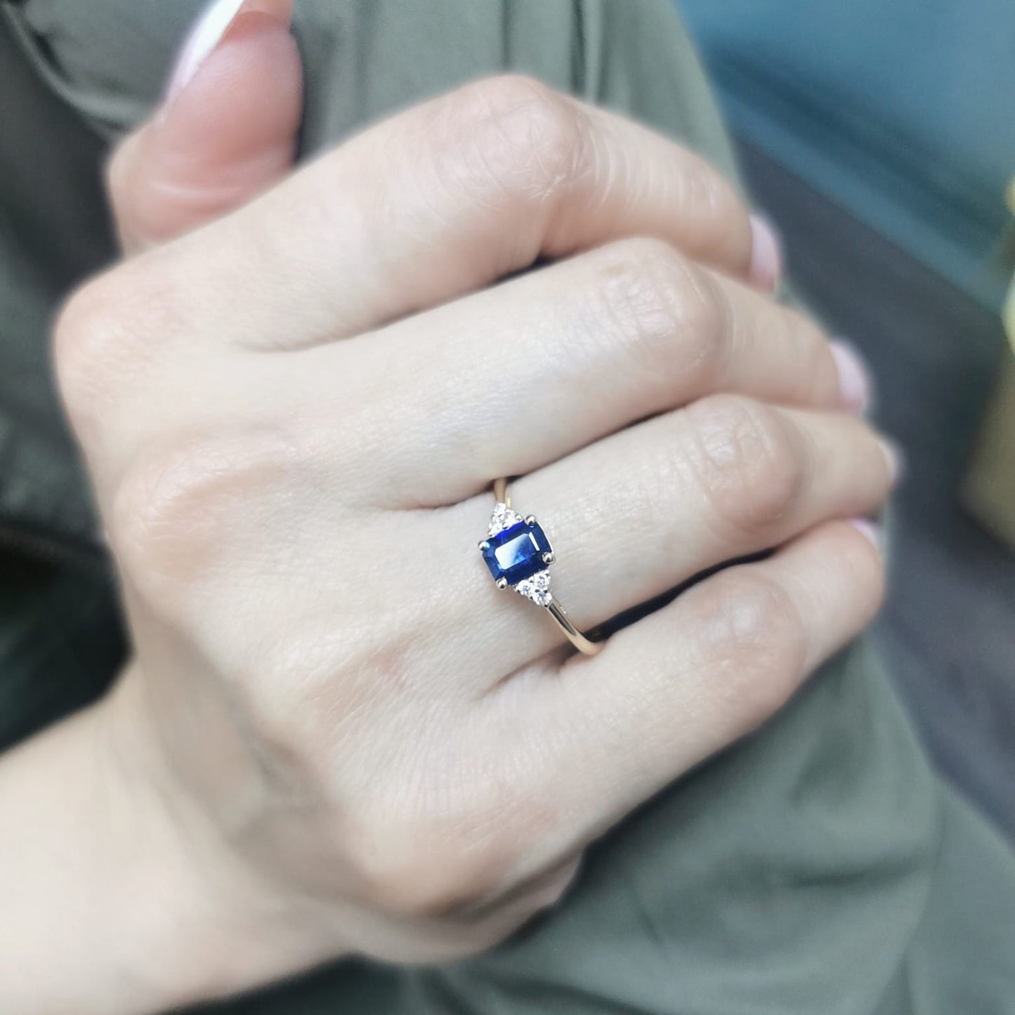 Petite 18K gold ring featuring a 0.68-carat emerald-cut blue sapphire, accented by 0.08-carat diamonds. Perfect for stacking or wearing alone.