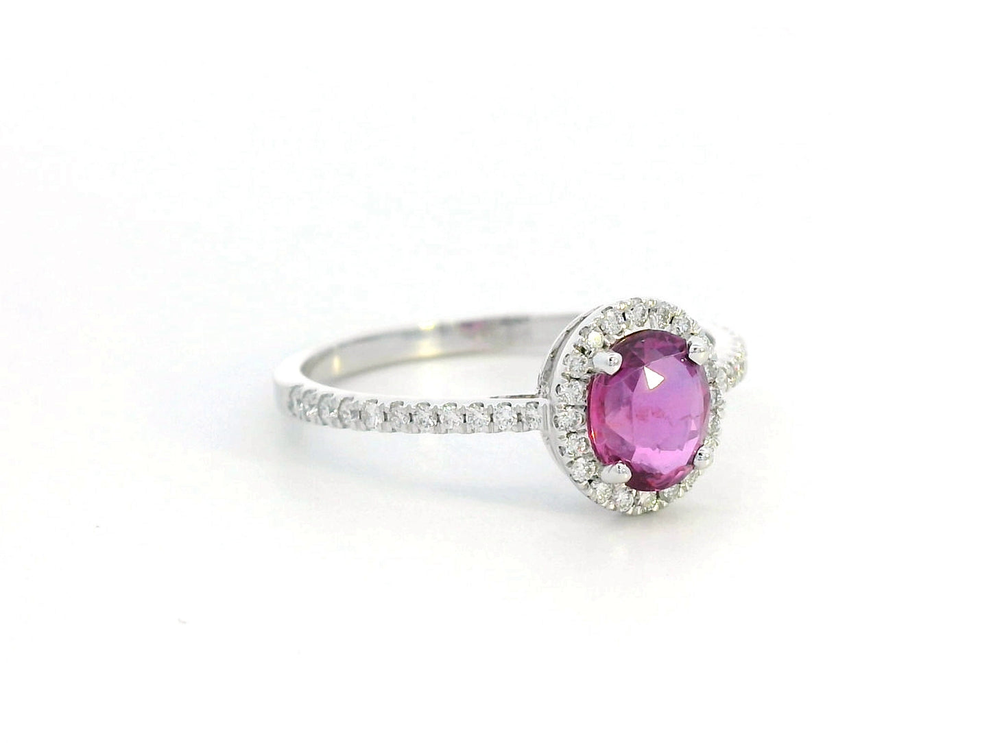 18K gold pink sapphire halo ring with 0.99 Ct oval pink sapphire and 0.22 Ct diamond accents, luxury gemstone jewelry