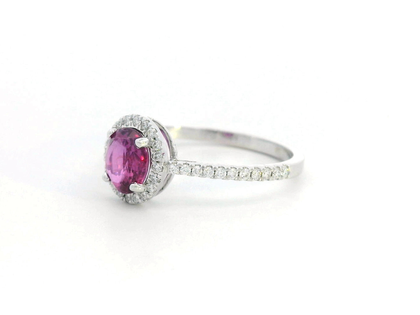 18K gold pink sapphire halo ring with 0.99 Ct oval pink sapphire and 0.22 Ct diamond accents, luxury gemstone jewelry