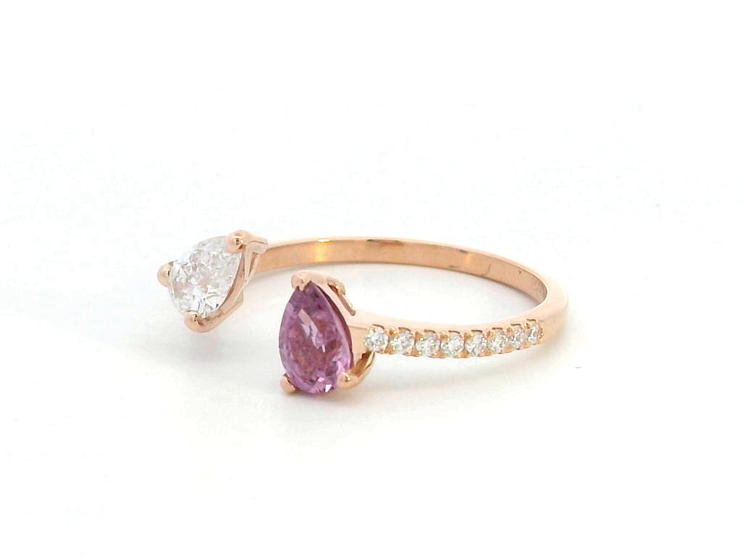 Elegant 18K gold Toi et Moi ring featuring a 0.46 carat pear-cut pink sapphire and a pear-cut diamond, with a total diamond weight of 0.42 carats, including accent diamonds on the band. A timeless and romantic fine jewelry piece.