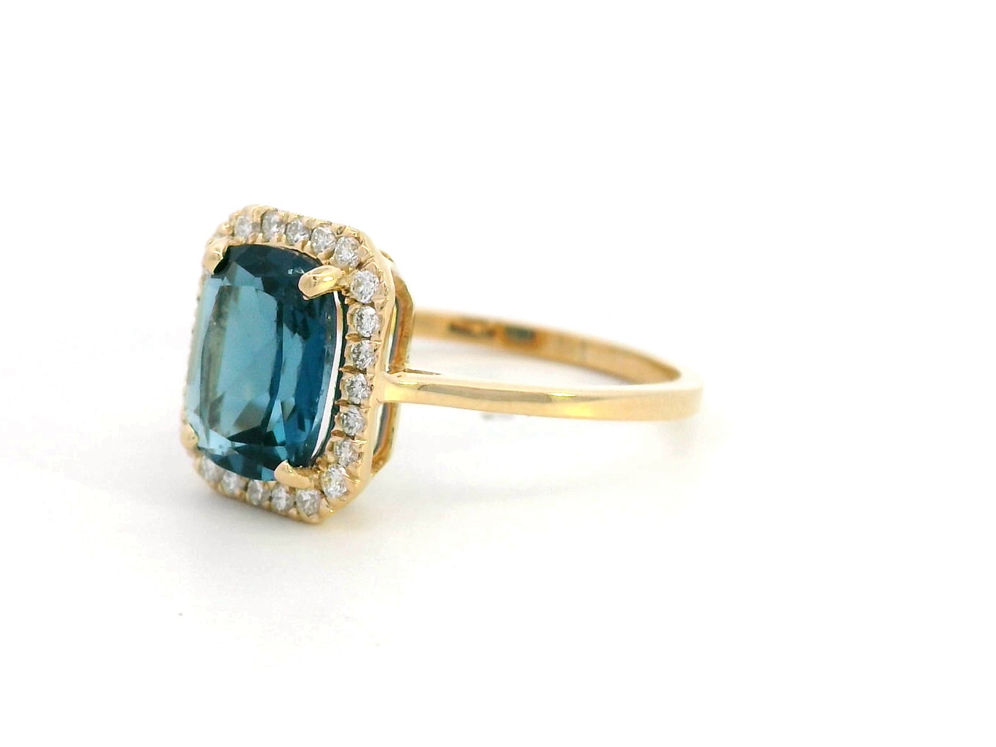 Emerald-cut 2.25-carat London Blue Topaz ring with 0.19-carat diamond accents in 18K yellow gold. December birthstone