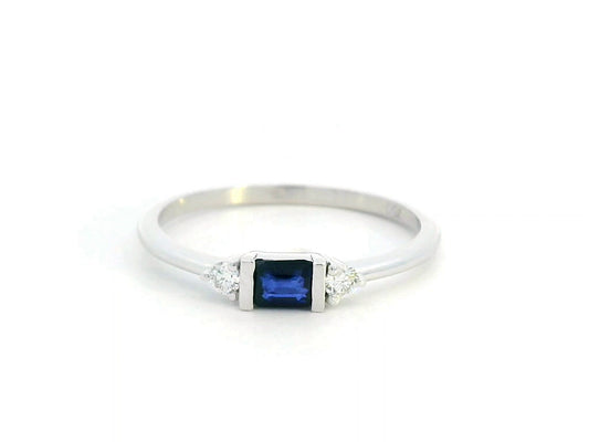 18K gold ring with a baguette-cut blue sapphire (0.26 carats) and round-cut diamonds (0.08 carats), bezel-set on a slim band—perfect for stacking or wearing alone.