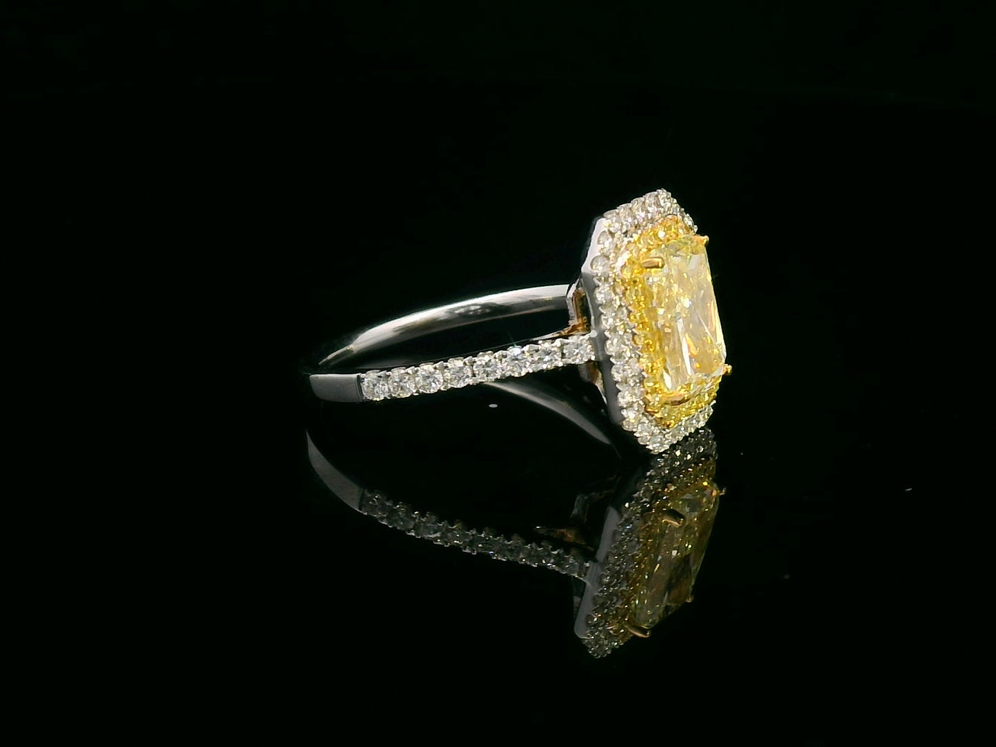 GIA-certified 2.02-carat fancy yellow radiant-cut diamond engagement ring with a double halo of yellow and white diamonds, accent diamonds set on an 18K gold band.