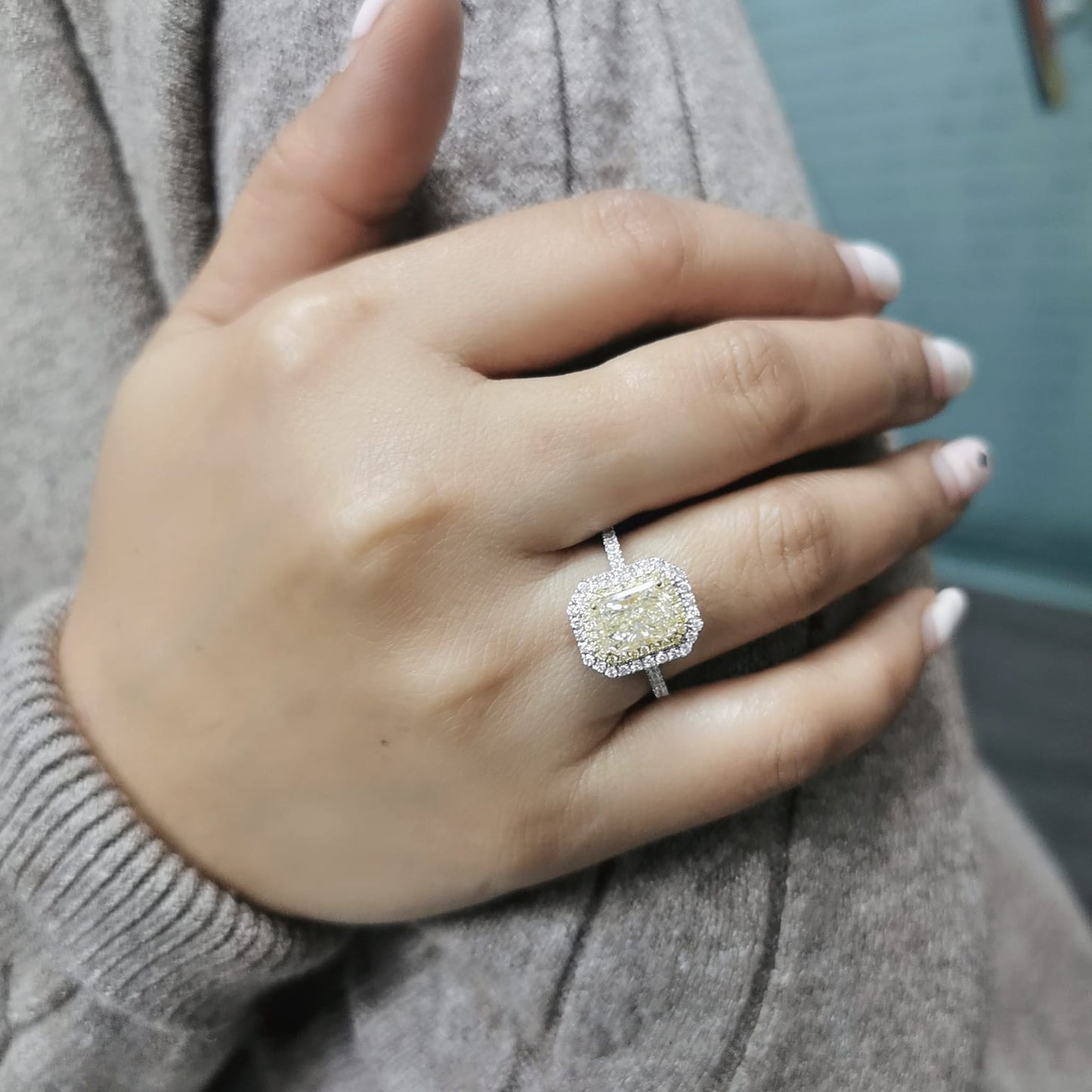 GIA-certified 2.02-carat fancy yellow radiant-cut diamond engagement ring with a double halo of yellow and white diamonds, accent diamonds set on an 18K gold band.