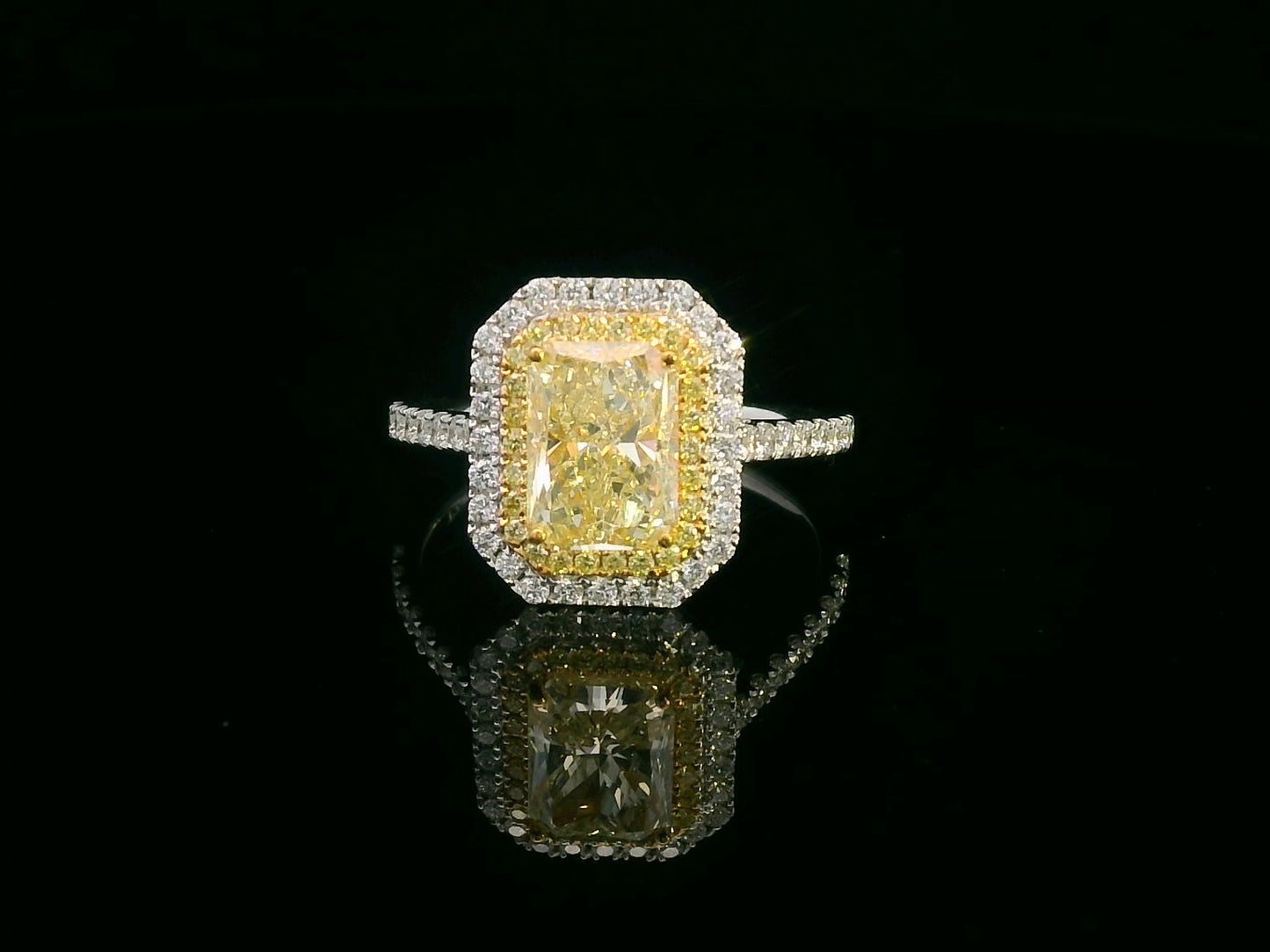 GIA-certified 2.02-carat fancy yellow radiant-cut diamond engagement ring with a double halo of yellow and white diamonds, accent diamonds set on an 18K gold band.