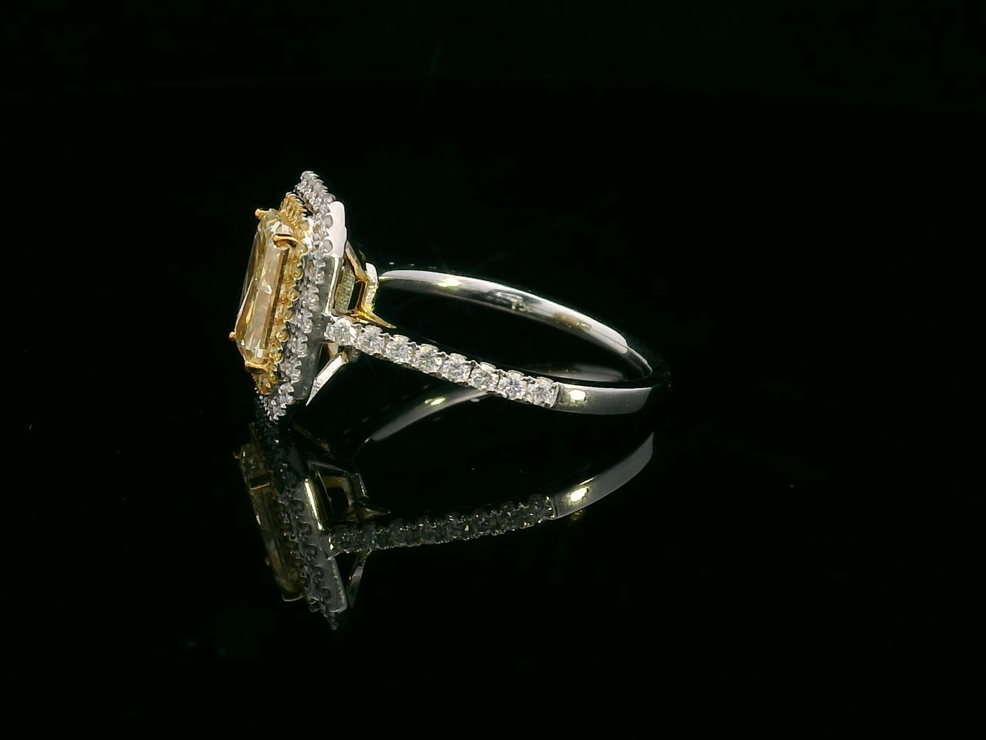 GIA-certified 2.02-carat fancy yellow radiant-cut diamond engagement ring with a double halo of yellow and white diamonds, accent diamonds set on an 18K gold band.