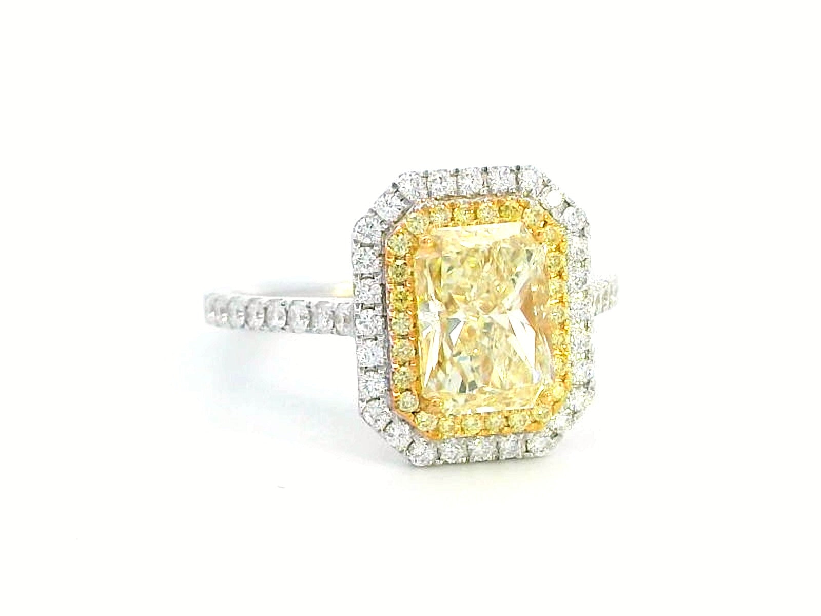 GIA-certified 2.02-carat fancy yellow radiant-cut diamond engagement ring with a double halo of yellow and white diamonds, accent diamonds set on an 18K gold band.