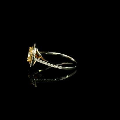 18K white gold engagement ring featuring a 1.50 carat GIA certified natural Fancy Yellow cushion cut diamond surrounded by a yellow diamond inner halo, white diamond outer halo, and diamond pavé band.
