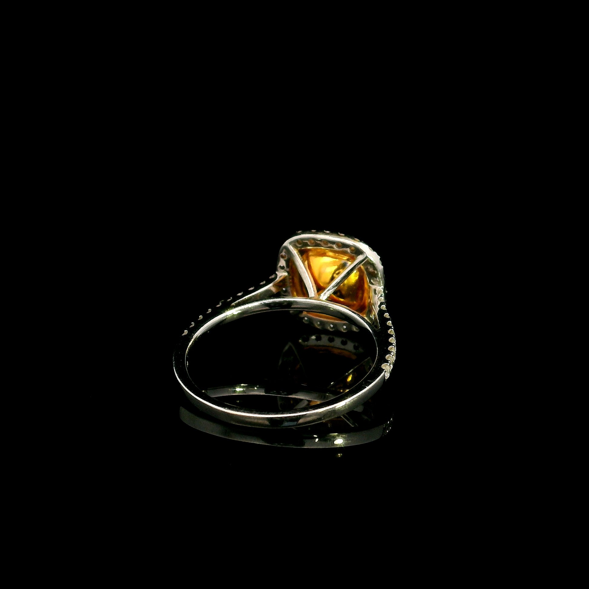 18K white gold engagement ring featuring a 1.50 carat GIA certified natural Fancy Yellow cushion cut diamond surrounded by a yellow diamond inner halo, white diamond outer halo, and diamond pavé band.