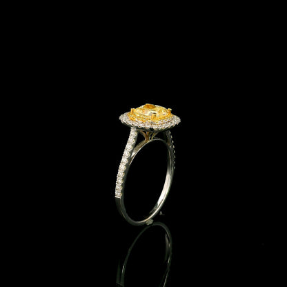 18K white gold engagement ring featuring a 1.50 carat GIA certified natural Fancy Yellow cushion cut diamond surrounded by a yellow diamond inner halo, white diamond outer halo, and diamond pavé band.