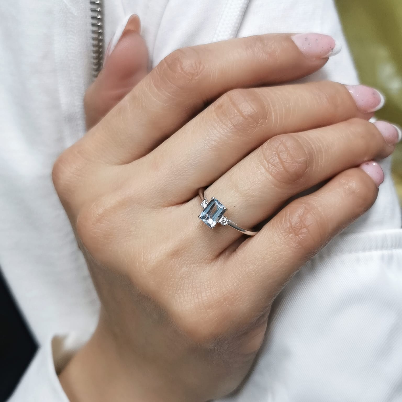 18K white gold aquamarine and diamond ring featuring a 0.65-carat emerald-cut aquamarine with 0.07-carat round diamonds in a minimalist fine jewelry design – perfect for engagements, gifts, and March birthstone jewelry.