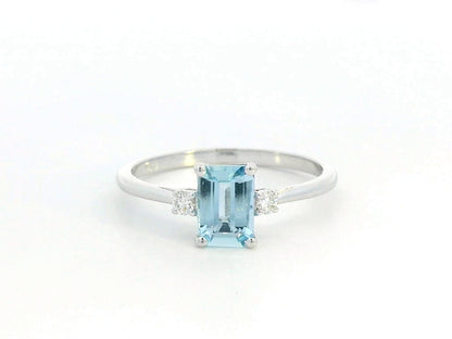 18K white gold aquamarine and diamond ring featuring a 0.65-carat emerald-cut aquamarine with 0.07-carat round diamonds in a minimalist fine jewelry design – perfect for engagements, gifts, and March birthstone jewelry.