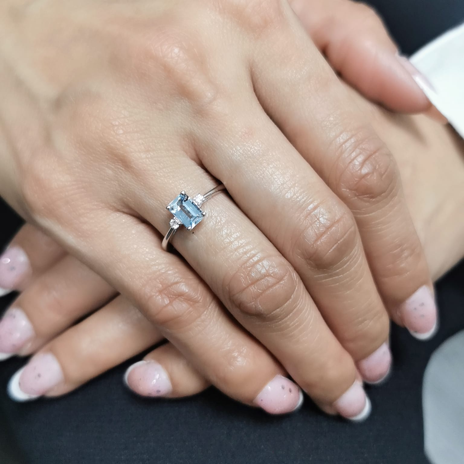 18K white gold aquamarine and diamond ring featuring a 0.65-carat emerald-cut aquamarine with 0.07-carat round diamonds in a minimalist fine jewelry design – perfect for engagements, gifts, and March birthstone jewelry.