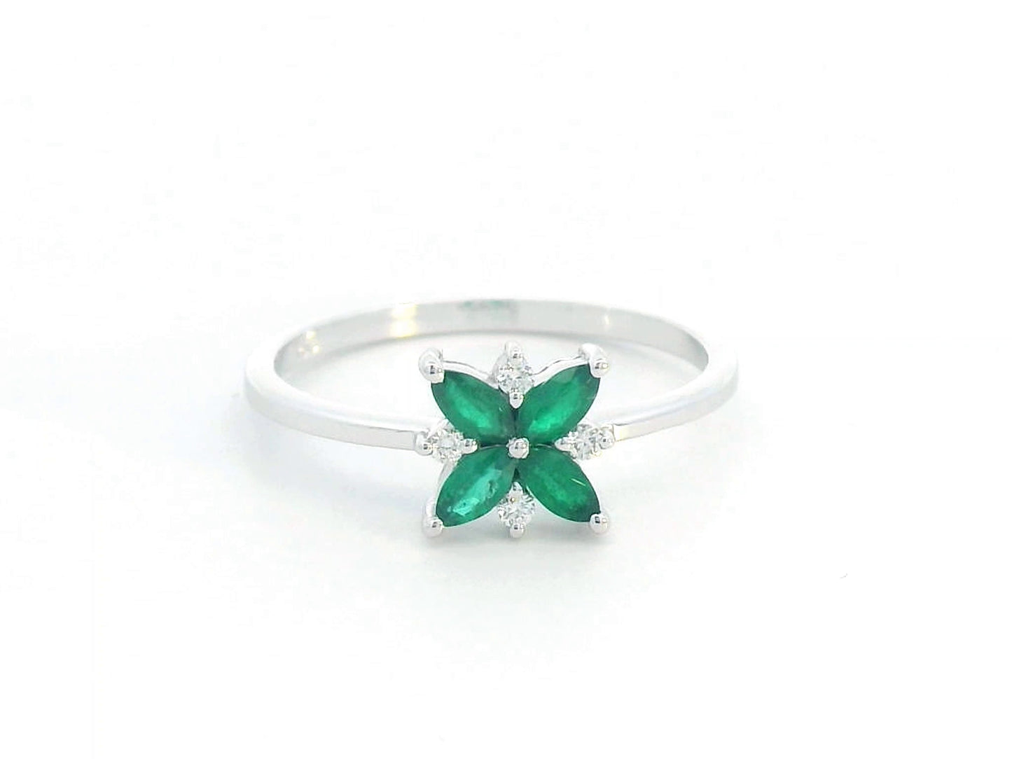 18K gold floral ring featuring 0.31 CT natural emeralds and 0.05 CT diamonds, designed in a delicate flower shape.