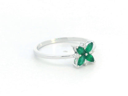 18K gold floral ring featuring 0.31 CT natural emeralds and 0.05 CT diamonds, designed in a delicate flower shape.