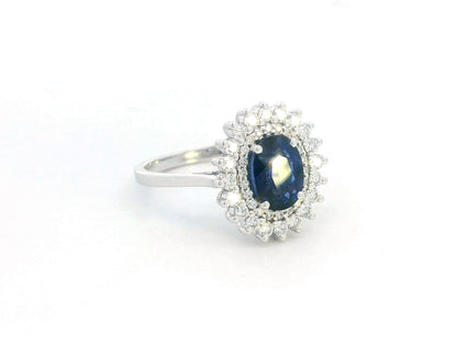 Elegant 2.00 carat sapphire halo ring with 0.53 carats of diamonds, set in 18K white gold. Classic halo design enhances brilliance—perfect as a September birthstone ring.