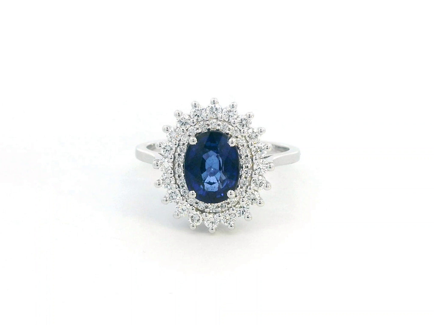 Elegant 2.00 carat sapphire halo ring with 0.53 carats of diamonds, set in 18K white gold. Classic halo design enhances brilliance—perfect as a September birthstone ring.