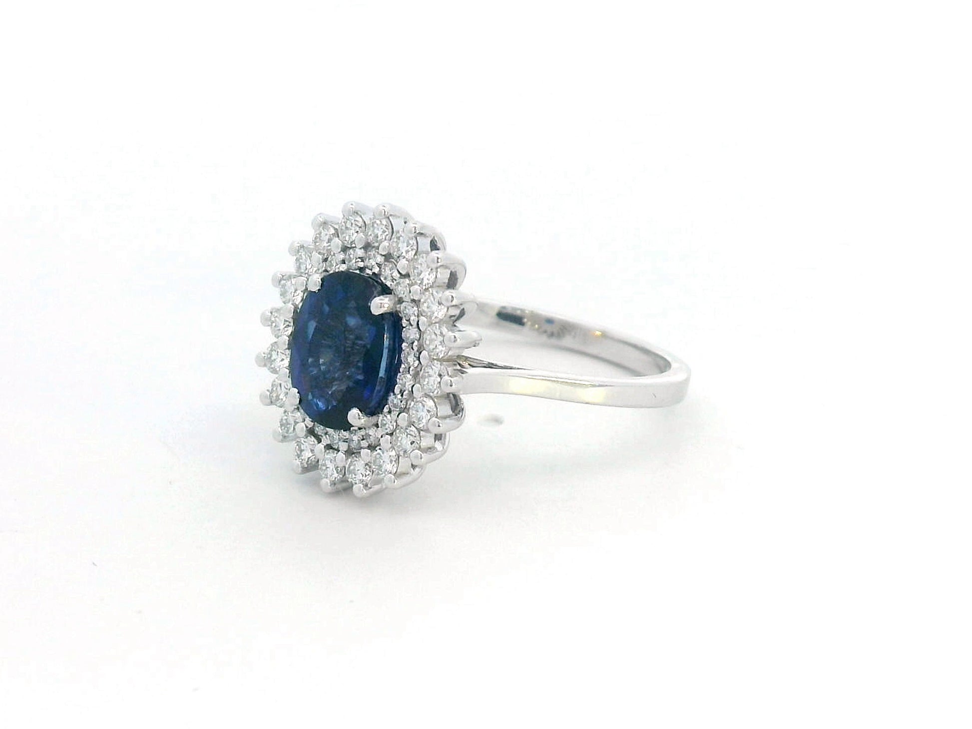 Elegant 2.00 carat sapphire halo ring with 0.53 carats of diamonds, set in 18K white gold. Classic halo design enhances brilliance—perfect as a September birthstone ring.