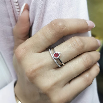 18K gold pear-shaped ruby and diamond ring with double-band design featuring a 0.30-carat ruby and 0.19-carat diamonds.