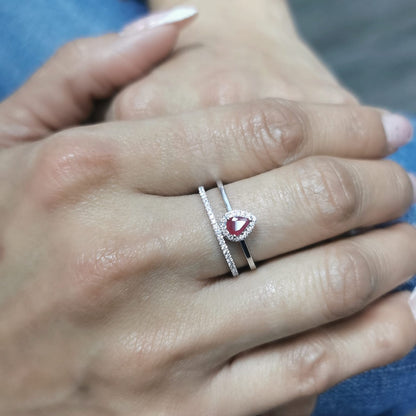 18K gold pear-shaped ruby and diamond ring with double-band design featuring a 0.30-carat ruby and 0.19-carat diamonds.