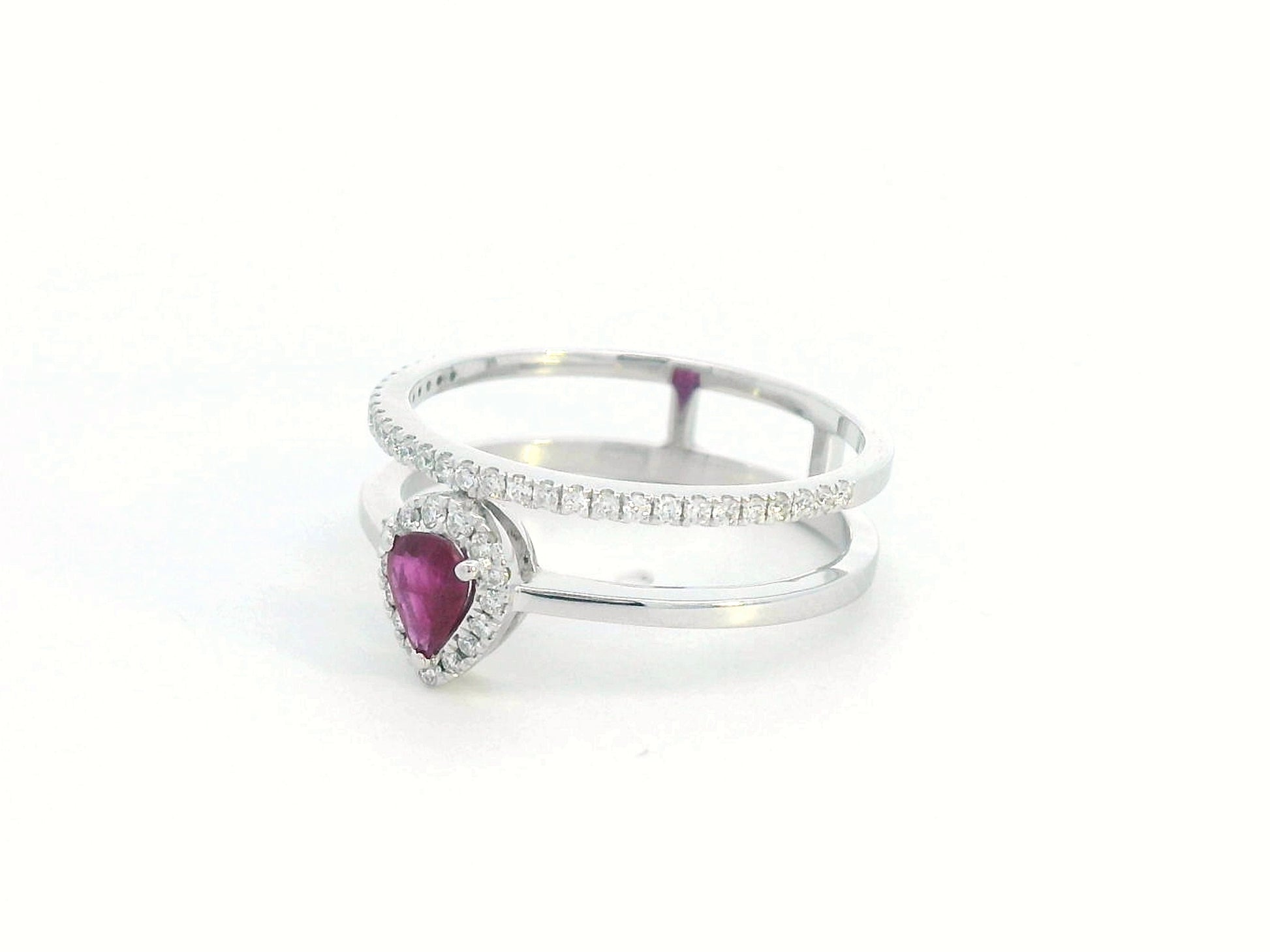 18K gold pear-shaped ruby and diamond ring with double-band design featuring a 0.30-carat ruby and 0.19-carat diamonds.