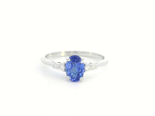 Elegant 0.94-carat oval Tanzanite and 0.10-carat Diamond ring in 18K white gold, perfect for engagements, anniversaries, and December birthstone jewelry