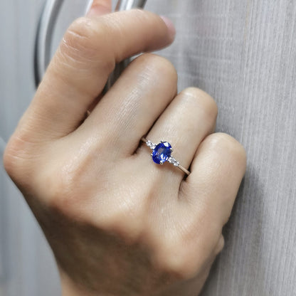 Elegant 0.94-carat oval Tanzanite and 0.10-carat Diamond ring in 18K white gold, perfect for engagements, anniversaries, and December birthstone jewelry