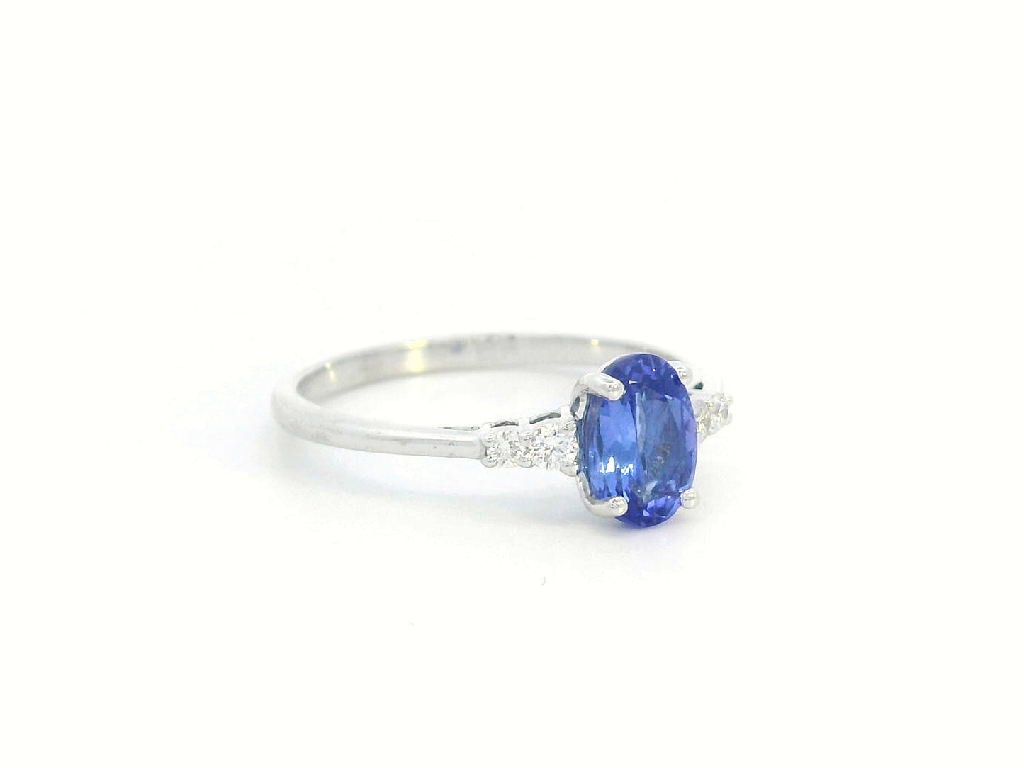 Elegant 0.94-carat oval Tanzanite and 0.10-carat Diamond ring in 18K white gold, perfect for engagements, anniversaries, and December birthstone jewelry