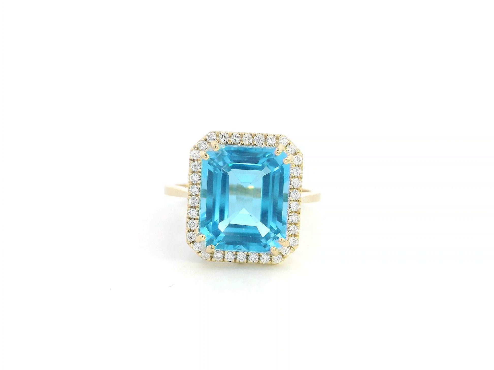 Elegant 7.62-carat emerald-cut Swiss Blue Topaz ring with a diamond halo, crafted in 18K White Gold – luxury cocktail ring