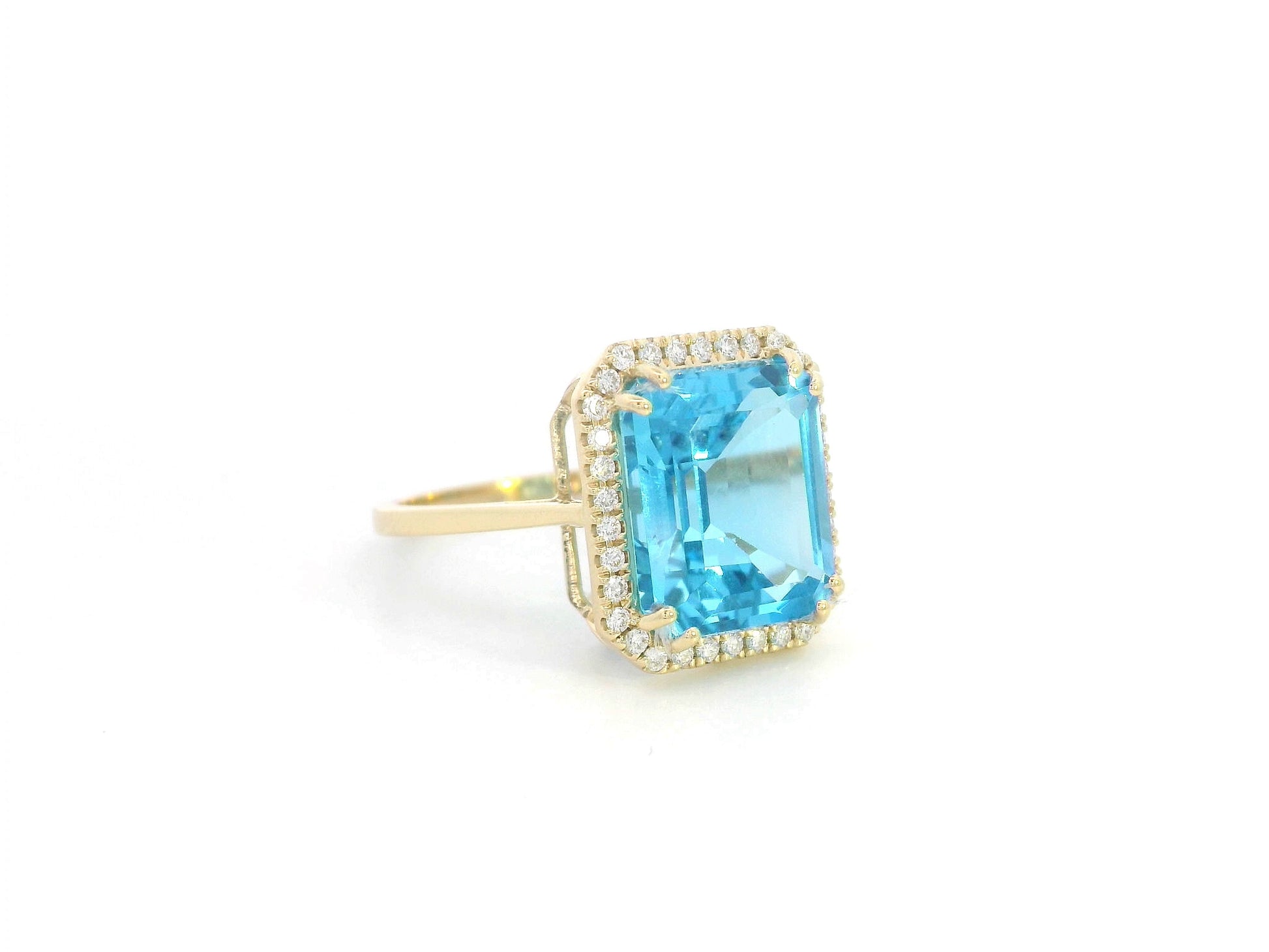 Elegant 7.62-carat emerald-cut Swiss Blue Topaz ring with a diamond halo, crafted in 18K White Gold – luxury cocktail ring