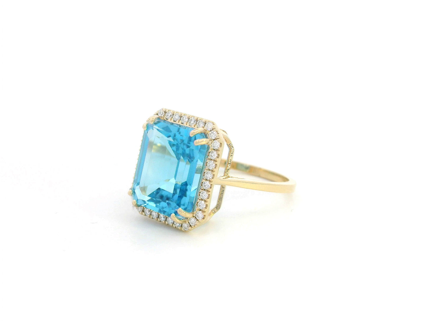 Elegant 7.62-carat emerald-cut Swiss Blue Topaz ring with a diamond halo, crafted in 18K White Gold – luxury cocktail ring