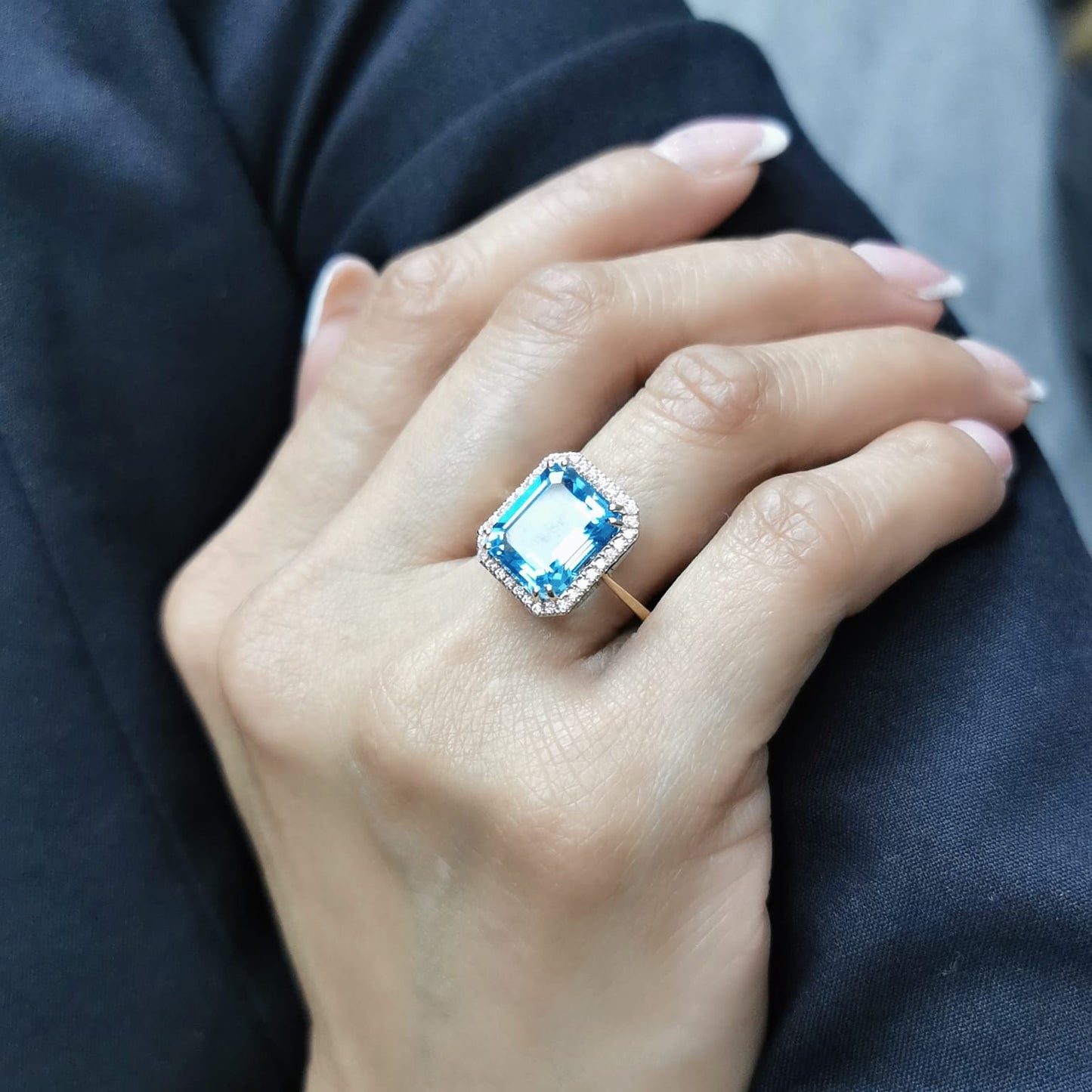 Elegant 7.62-carat emerald-cut Swiss Blue Topaz ring with a diamond halo, crafted in 18K White Gold – luxury cocktail ring