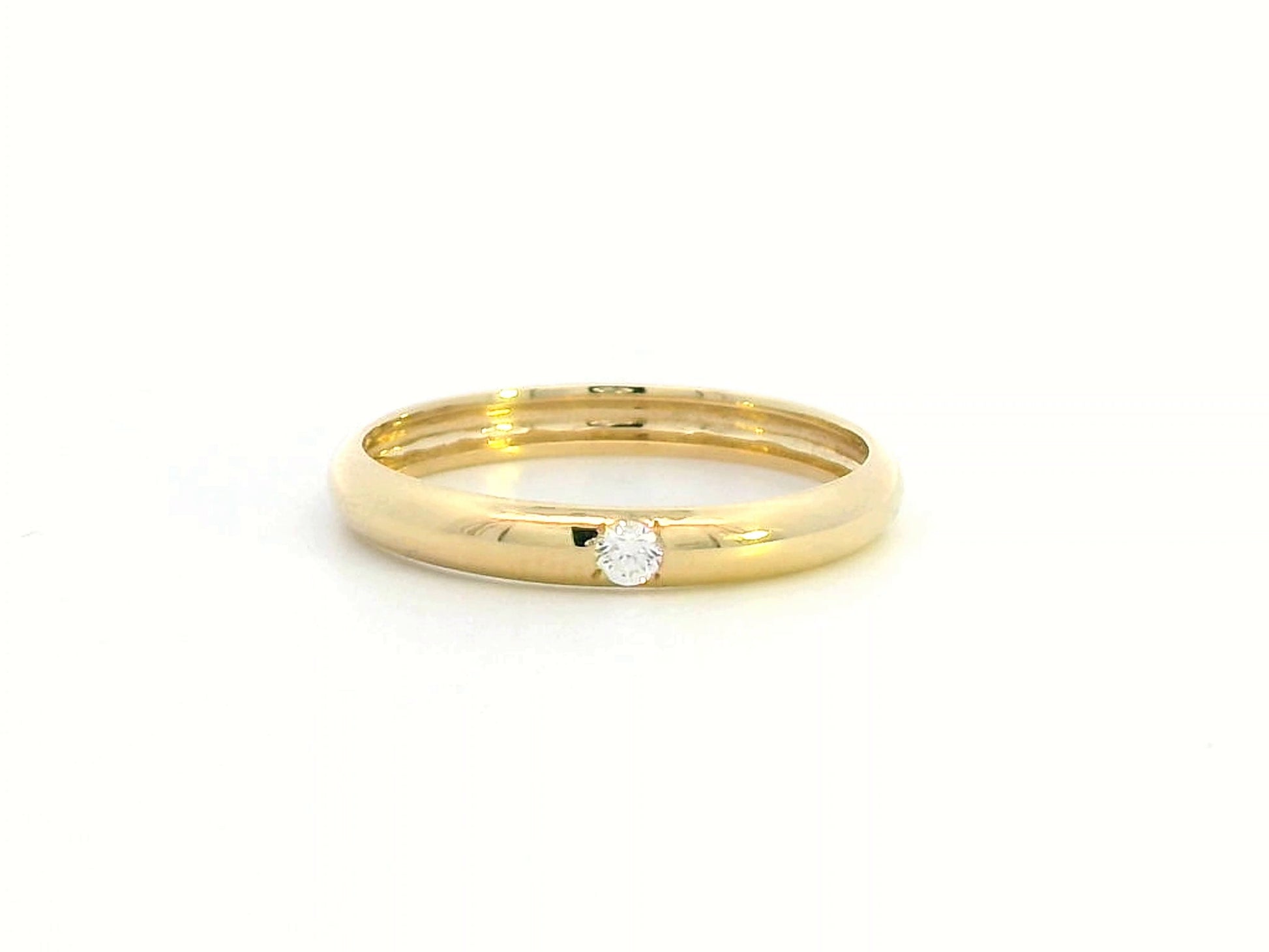 Minimalist 18K gold stackable ring with a 0.05-carat flush-set diamond, perfect as a wedding band, promise ring, or everyday stacking ring.