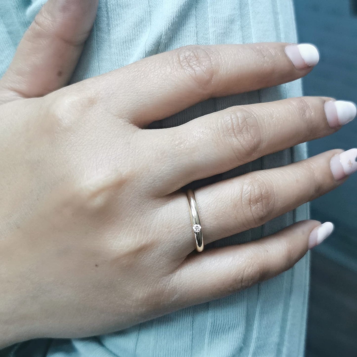 Minimalist 18K gold stackable ring with a 0.05-carat flush-set diamond, perfect as a wedding band, promise ring, or everyday stacking ring.