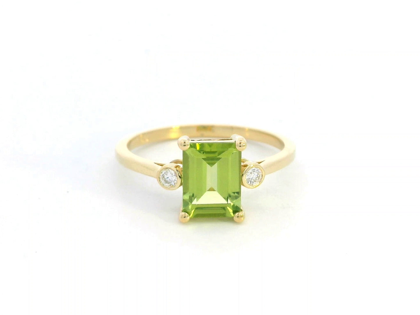 18K gold emerald-cut Peridot ring with 0.07ct diamond accents, featuring a vibrant 1.53ct Peridot centerpiece.