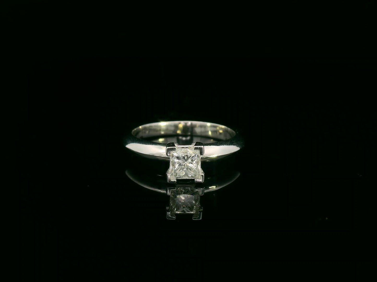 18K white gold solitaire ring with a 0.77ct princess-cut diamond, IGI certified, elegant minimalist engagement design by Emirates Diamonds.