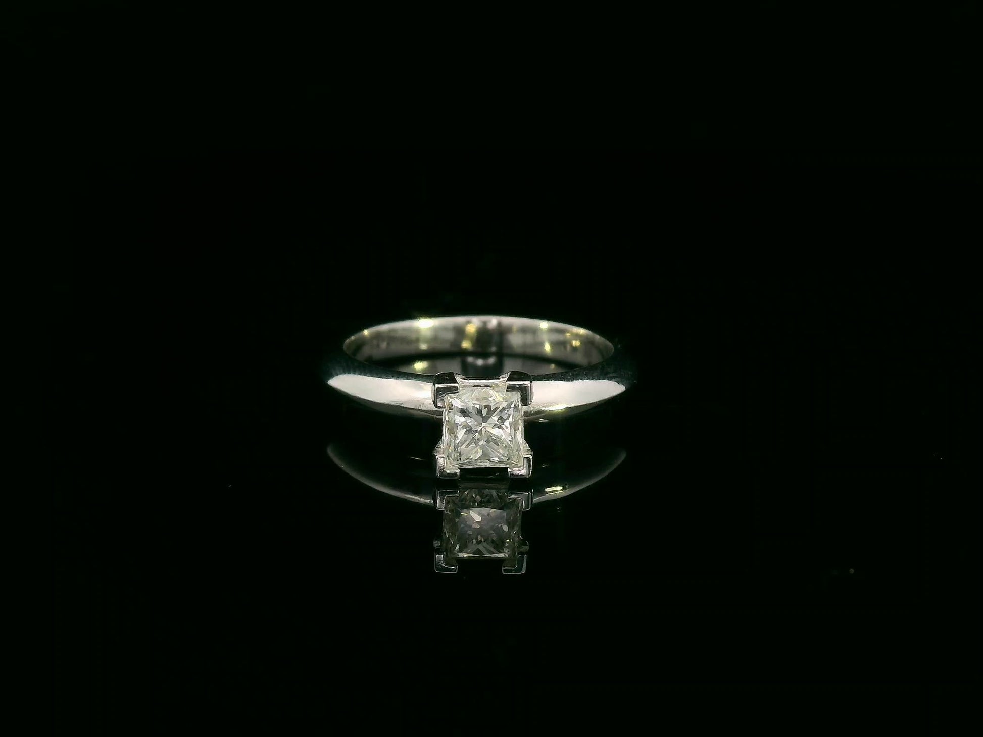 18K white gold solitaire ring with a 0.77ct princess-cut diamond, IGI certified, elegant minimalist engagement design by Emirates Diamonds.