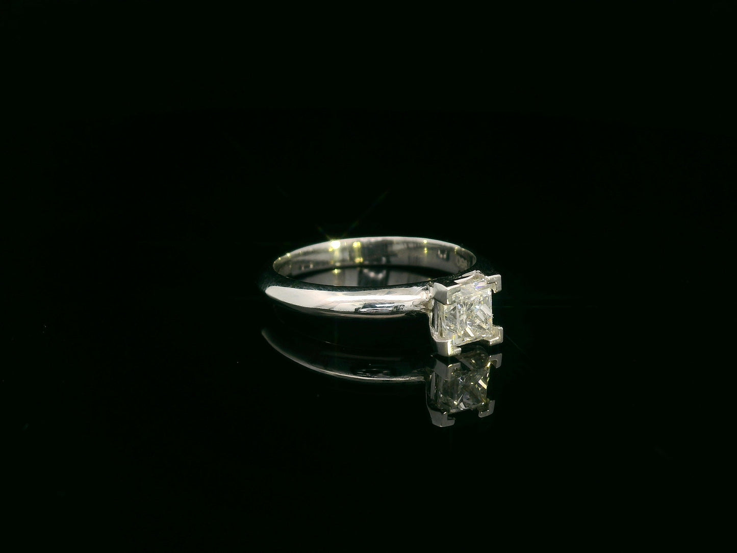 18K white gold solitaire ring with a 0.77ct princess-cut diamond, IGI certified, elegant minimalist engagement design by Emirates Diamonds.