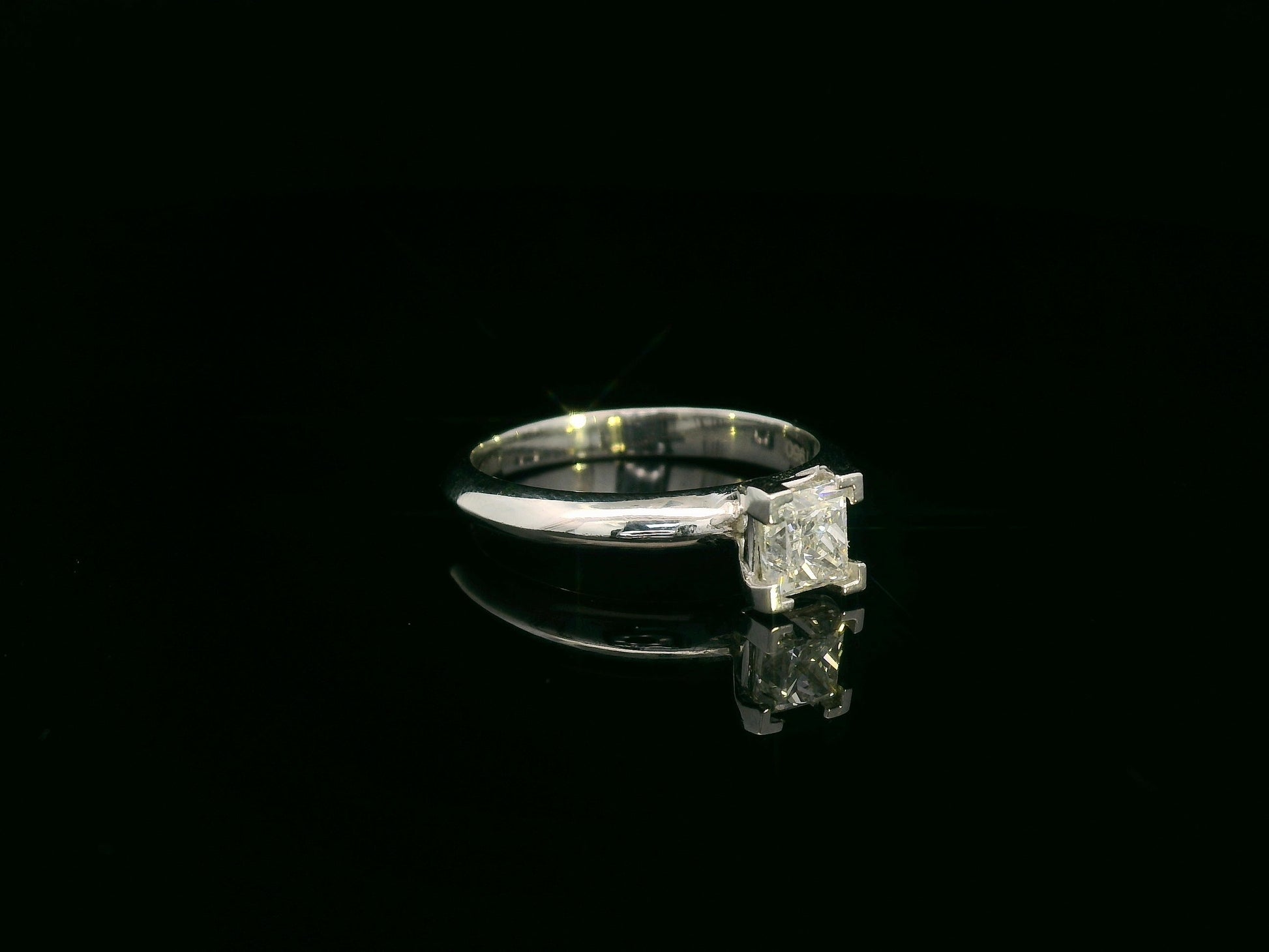 18K white gold solitaire ring with a 0.77ct princess-cut diamond, IGI certified, elegant minimalist engagement design by Emirates Diamonds.