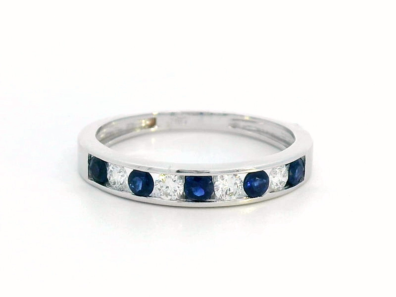 18K gold channel-set sapphire and diamond ring featuring 0.69-carat blue sapphires and 0.43-carat brilliant diamonds in a timeless eternity band design