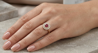 18K Yellow Gold Ruby Halo Ring featuring a 0.20 carat natural round ruby surrounded by 0.22 carats of natural diamonds.
