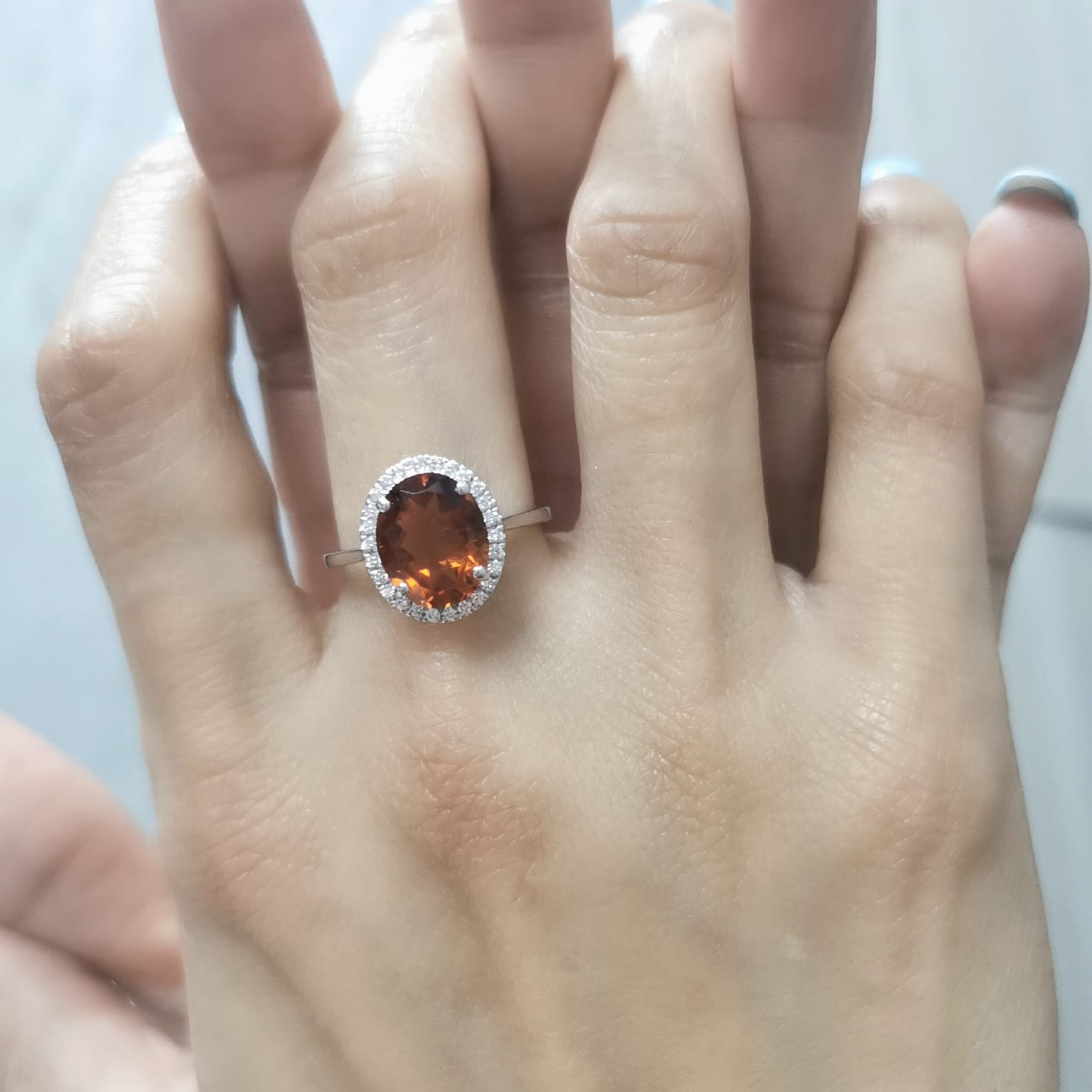 18K white gold ring with oval citrine center stone and round diamond halo