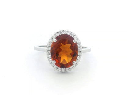 18K white gold ring with oval citrine center stone and round diamond halo