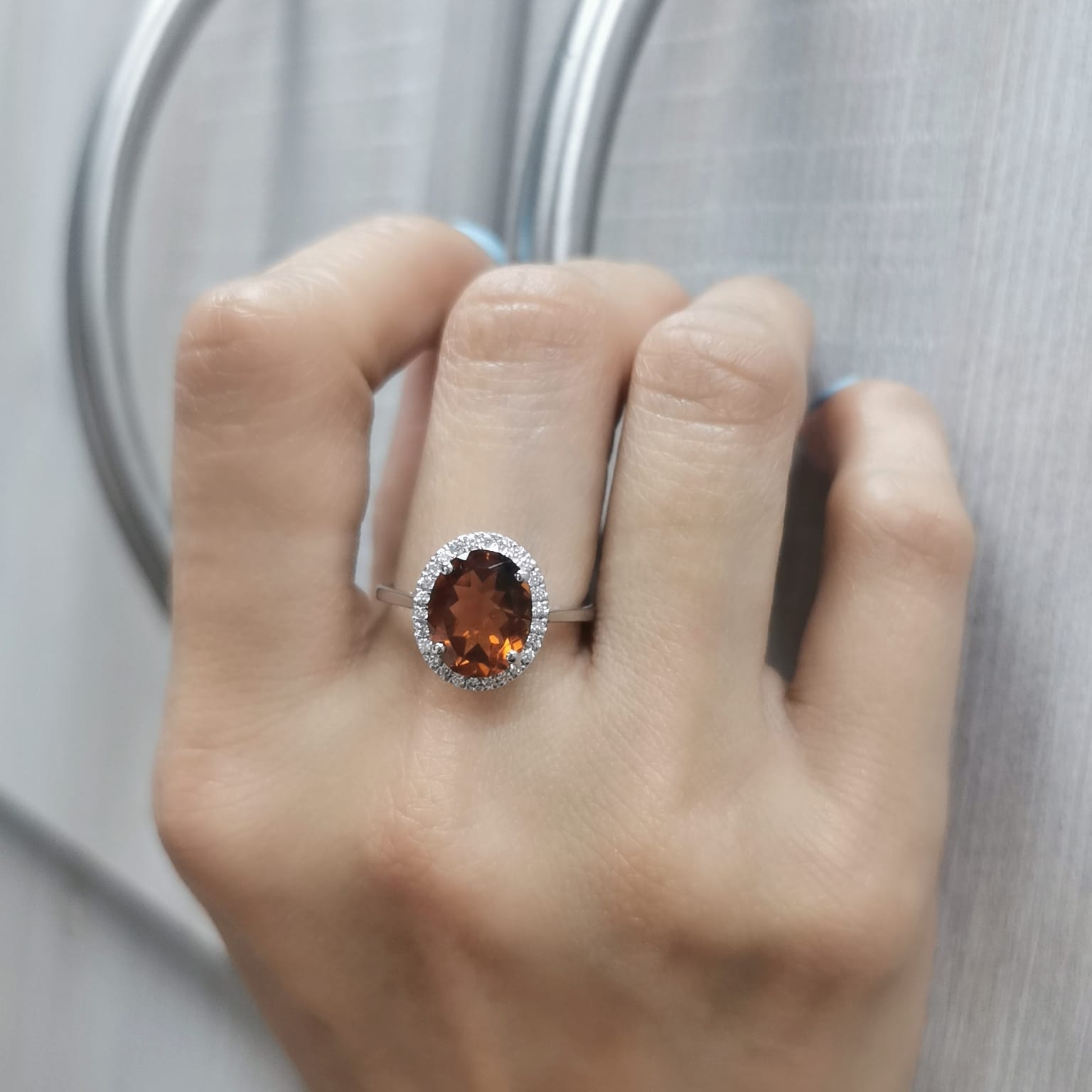 18K white gold ring with oval citrine center stone and round diamond halo