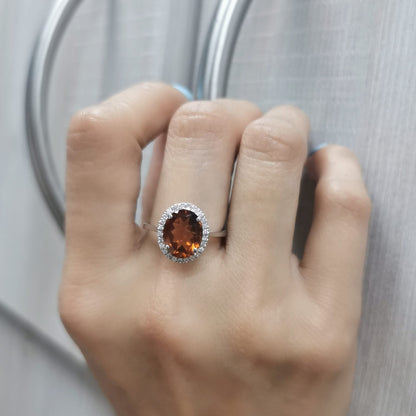 18K white gold ring with oval citrine center stone and round diamond halo