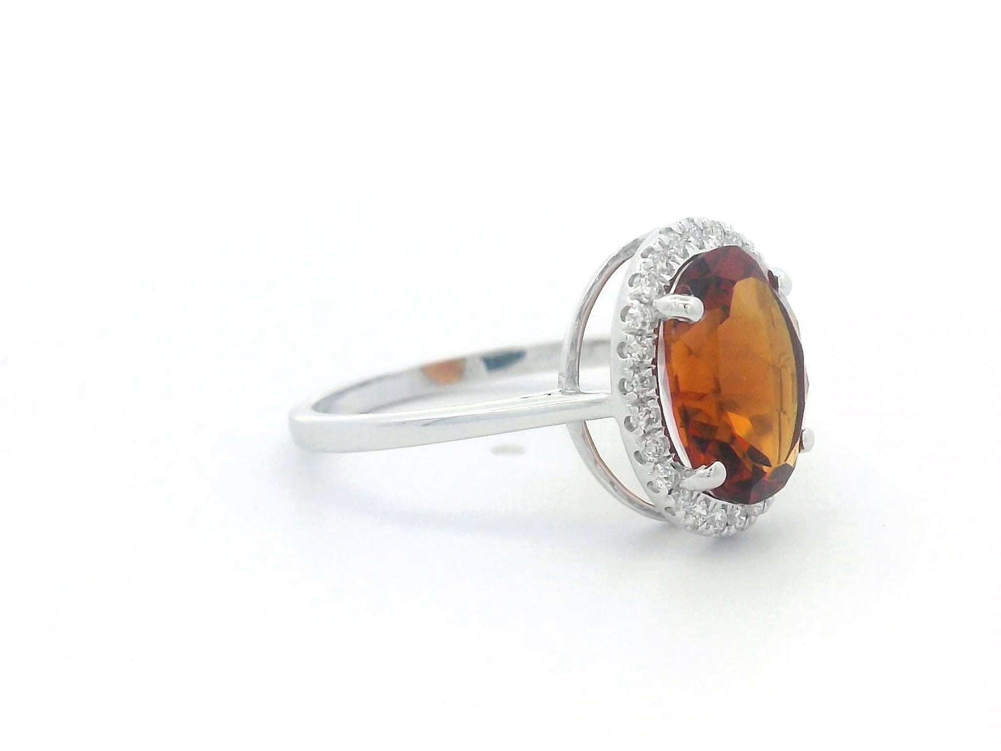 18K white gold ring with oval citrine center stone and round diamond halo