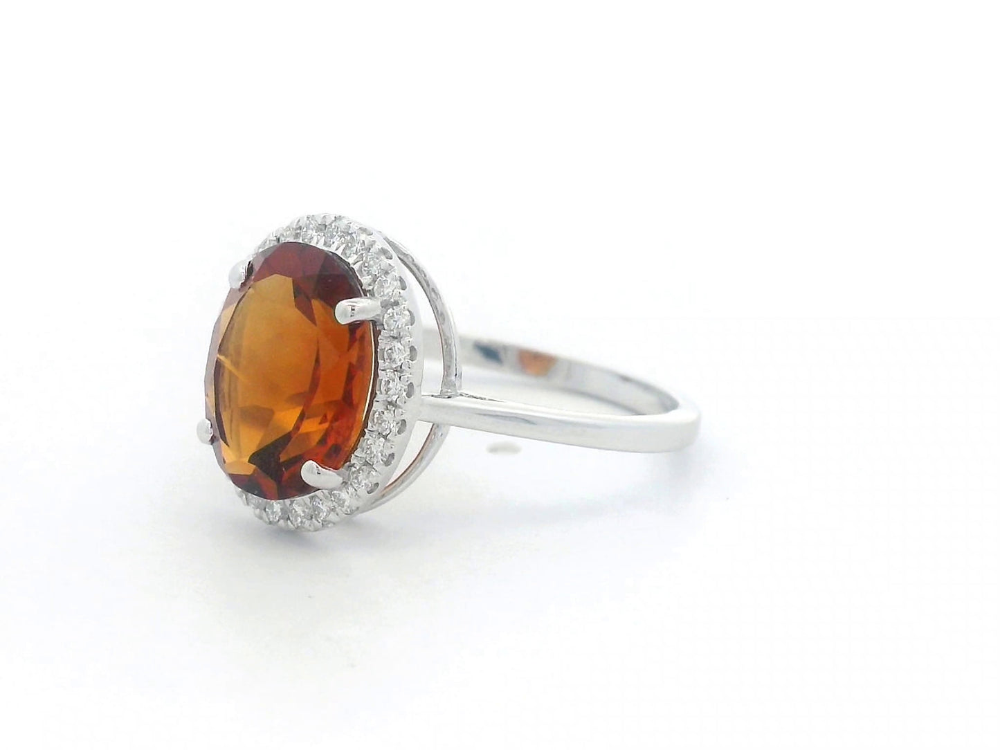 18K white gold ring with oval citrine center stone and round diamond halo