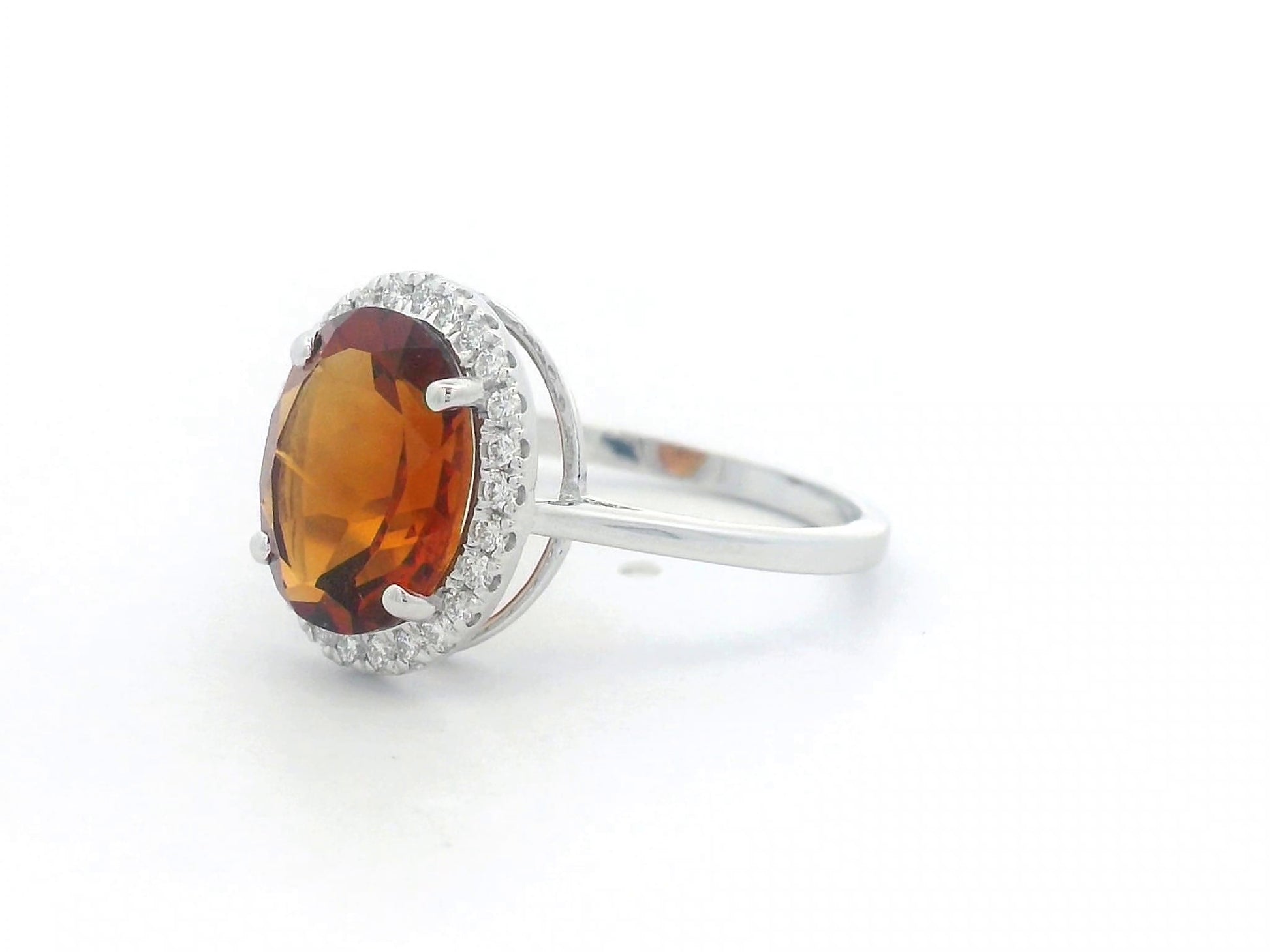 18K white gold ring with oval citrine center stone and round diamond halo