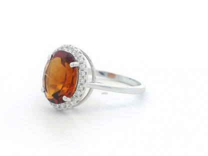 18K white gold ring with oval citrine center stone and round diamond halo